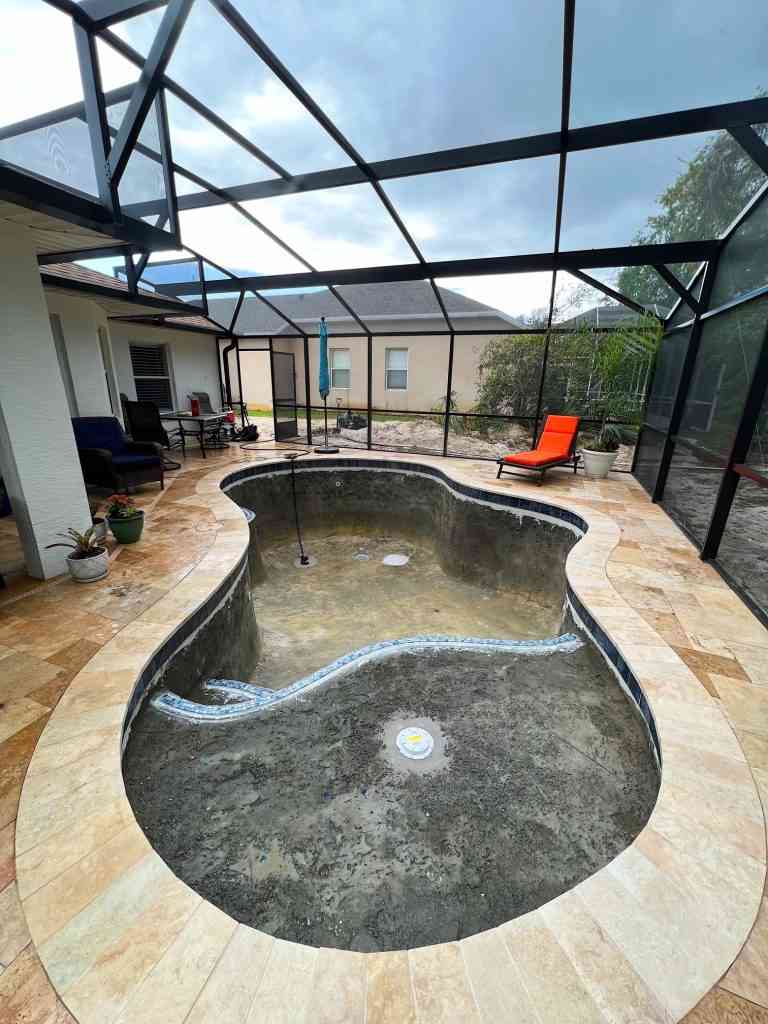 Travertine pavers installed for new pool construction in Palm Coast