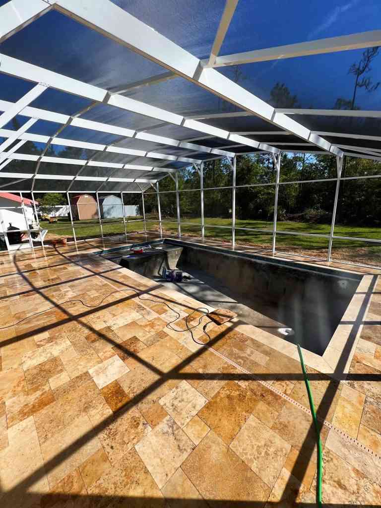 Travertine pavers and screen enclosure completed