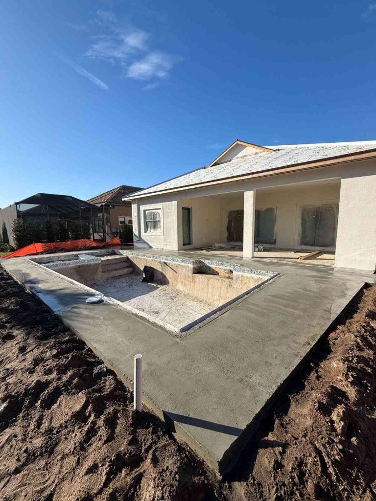 Custom gunite pool construction in Palm Coast with flush spa and sun deck
