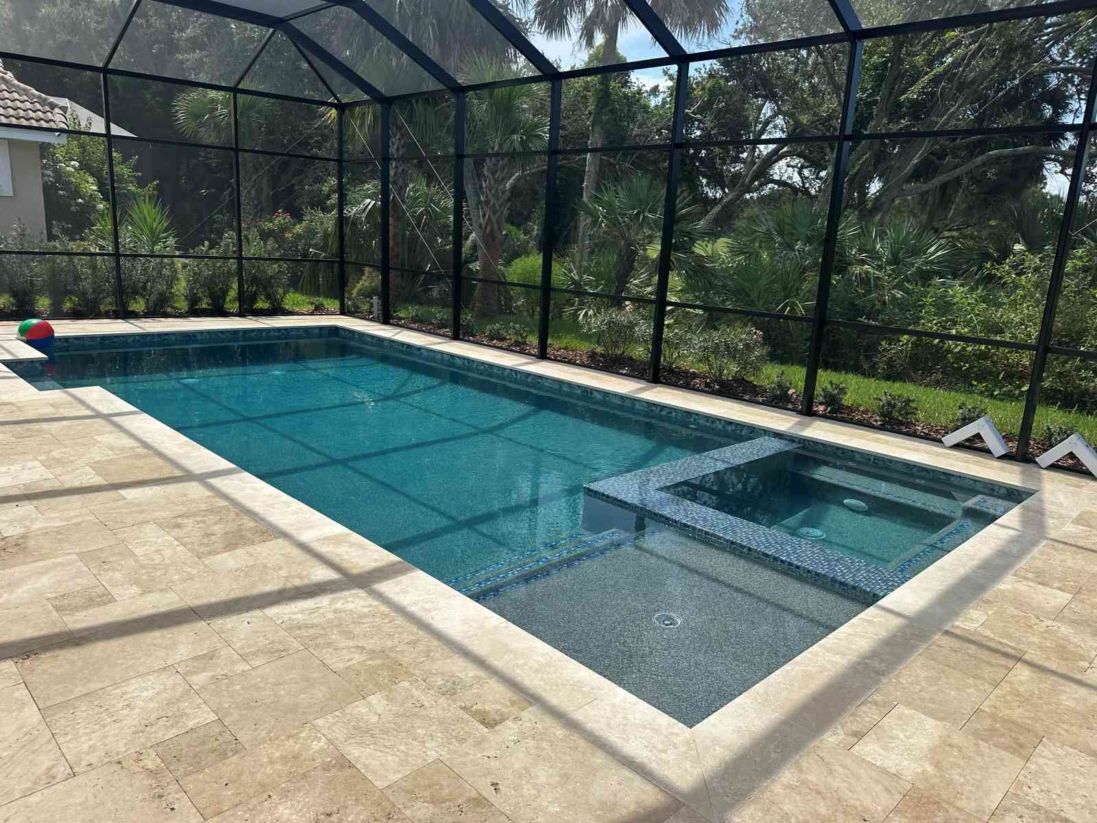 Custom pool with flush spa and sun deck in Palm Coast