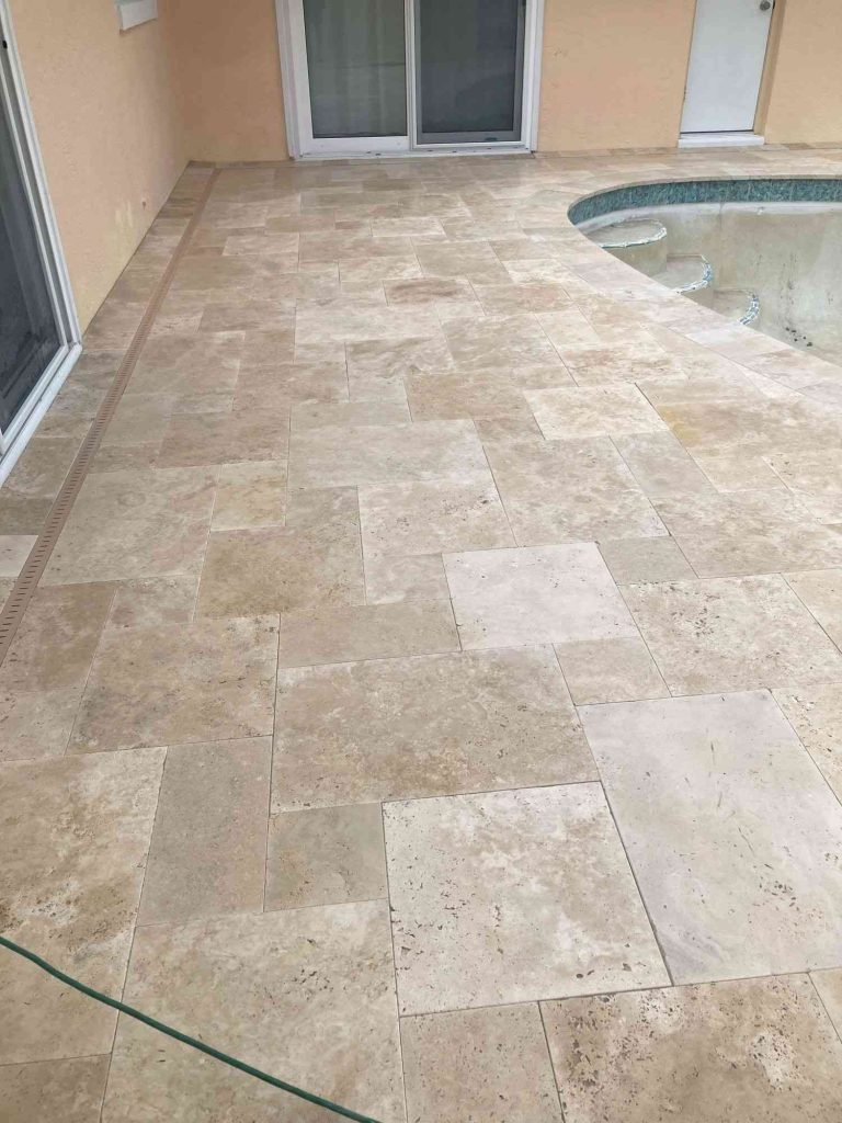 Ivory travertine paver deck in French pattern