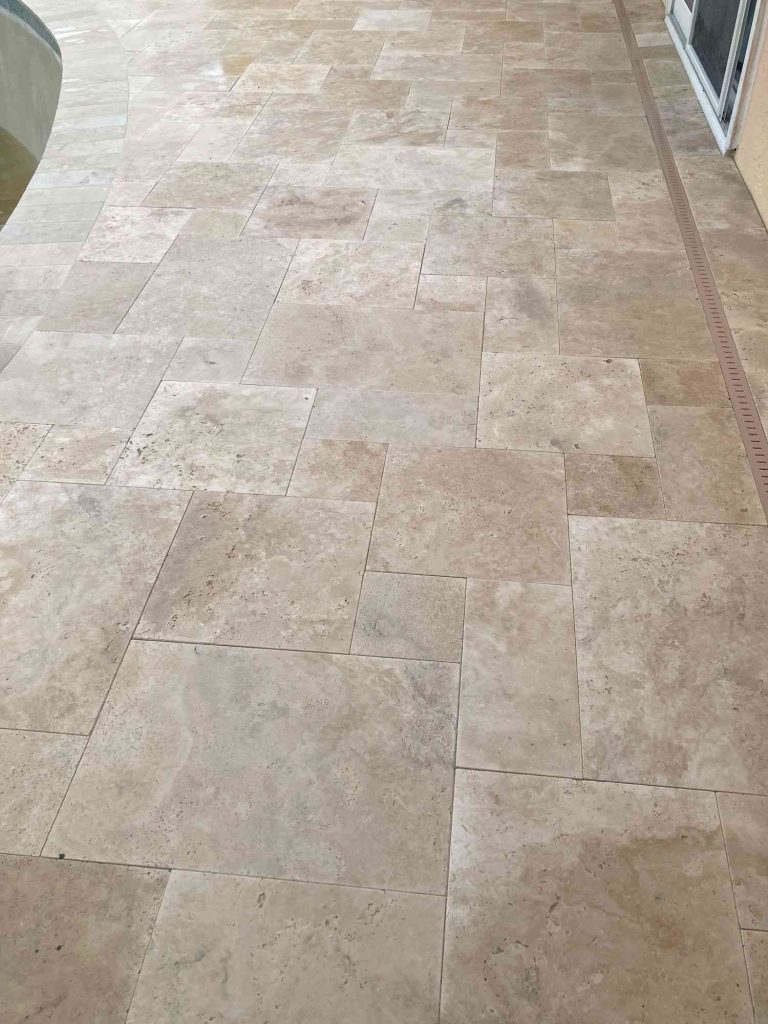 Ivory travertine paver deck in French pattern