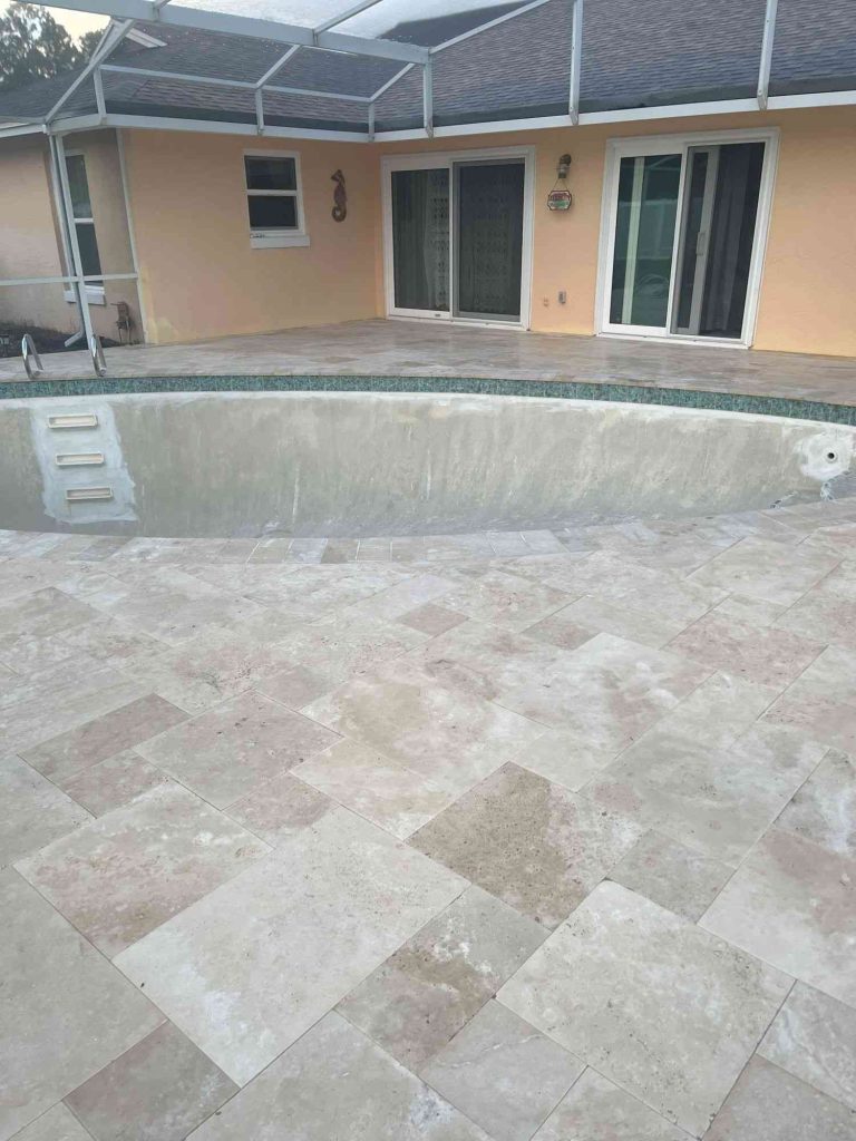 Ivory travertine paver deck in French pattern
