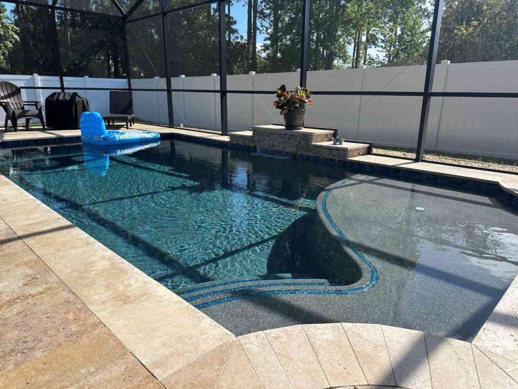 custom pool construction in Palm Coast with sun shelf and raised wall water feature