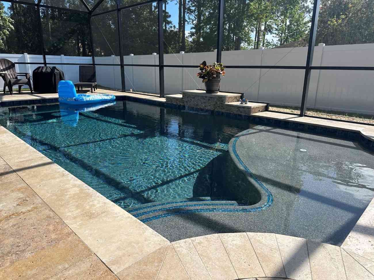 custom pool construction in Palm Coast with sun shelf and raised wall water feature