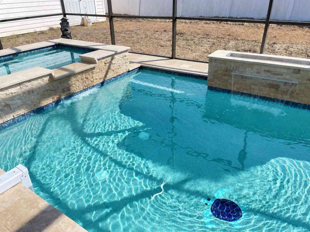 Custom pool with spa combo in Palm Coast with Wet Edge lifetime interior finish