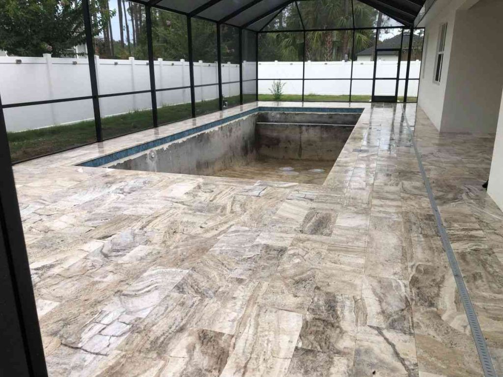 Travertine pavers installed over concrete subdeck