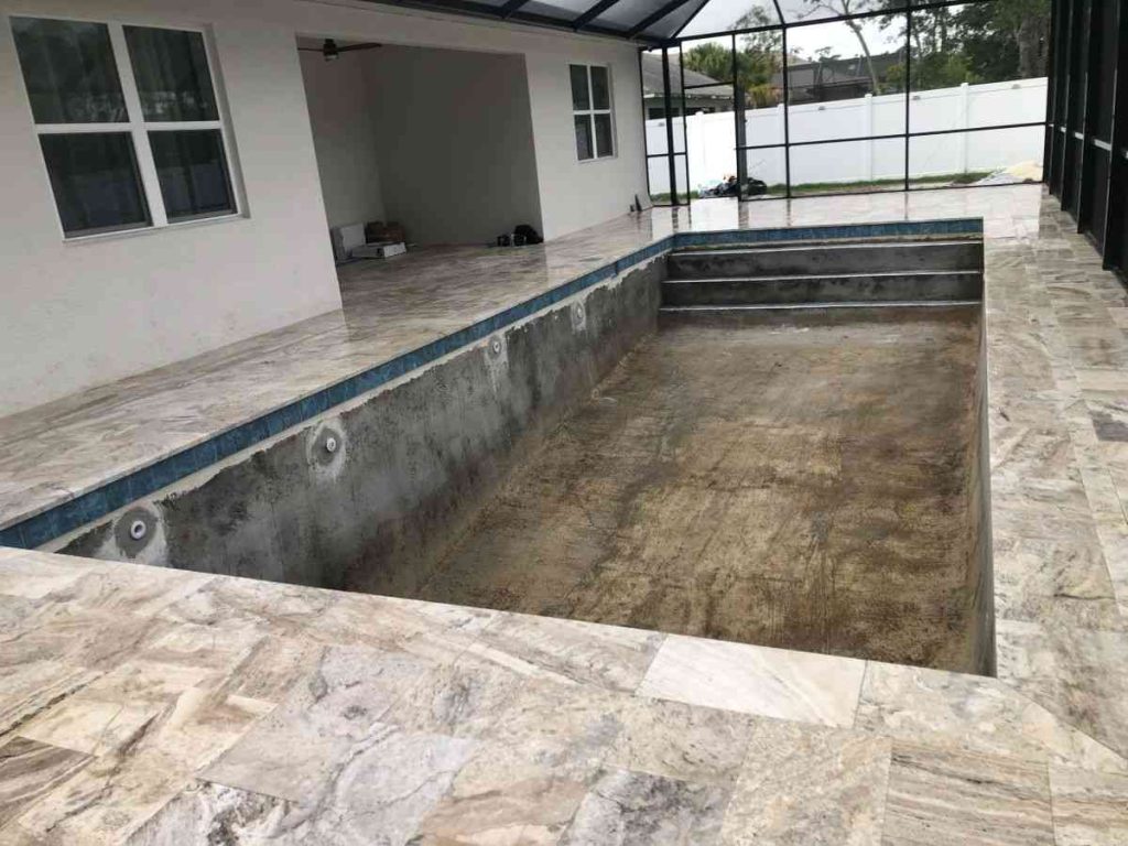 Travertine pavers installed over concrete subdeck